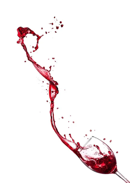 Červené víno, stříkající ze skla na bílém pozadí — Stock fotografie