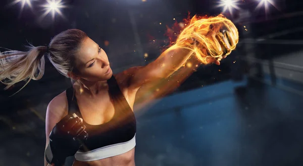 Young blond woman with fire fist — Stock Photo, Image