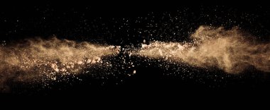 Abstract colored brown powder explosion isolated on black backgr clipart