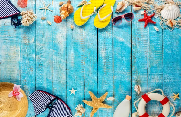 Beach accessories placed on blue wooden planks, top view. — Stock Photo, Image