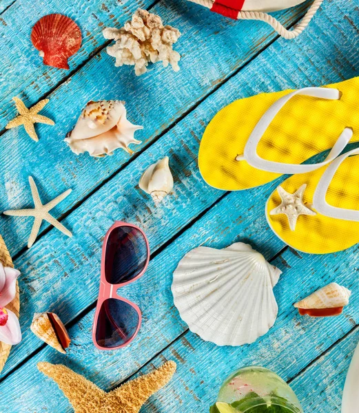 Beach accessories placed on blue wooden planks, top view. — Stock Photo, Image