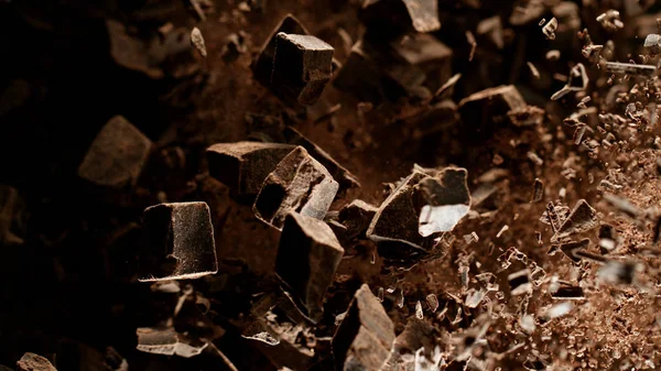 Freeze motion of flying group of raw chocolate pieces. — Stock Photo, Image