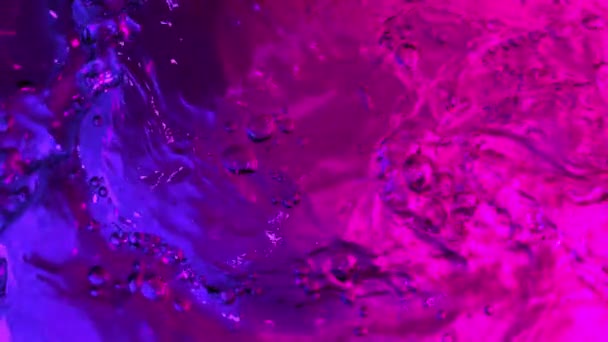 Super Slow Motion Splashing Water Illuminated Neon Lights Filmed Very — Stock Video