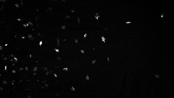Super Slow Motion Flying Silver Confetti Stars Shapes Black Background — Vídeos de Stock