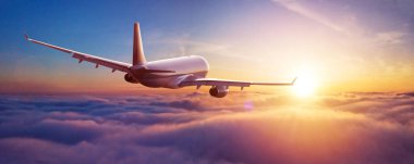 Passengers commercial airplane flying above clouds clipart