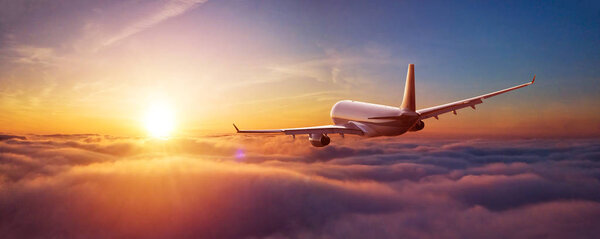 Passengers commercial airplane flying above clouds