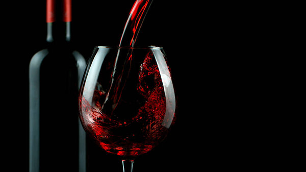 Detail of pouring red wine into glass