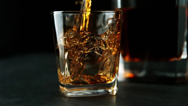 Detail of pouring whiskey into glass — Stock Photo, Image