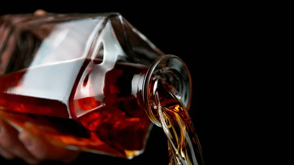 Detail of pouring whiskey from bottle — Stock Photo, Image