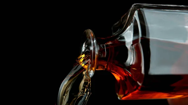 Detail of pouring whiskey from bottle — Stock Photo, Image