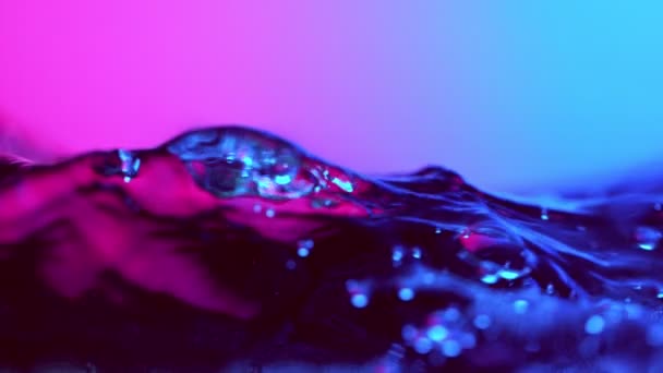 Super Slow Motion Splashing Water Wave Illuminated Neon Lights Filmed — Stock Video