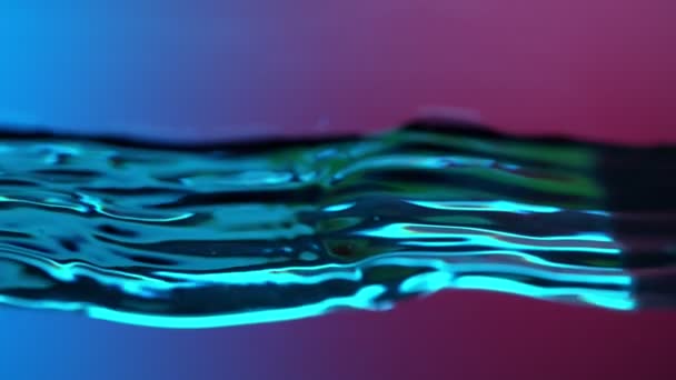 Super Slow Motion Splashing Water Wave Illuminated Neon Lights Filmed — Stock Video