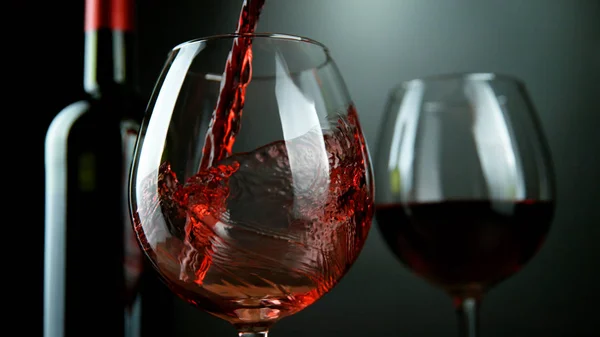 Detail of pouring red wine into glass