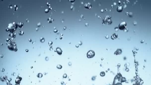 Super Slow Motion Flying Water Splashes Soft Blue Background Filmado — Vídeo de Stock