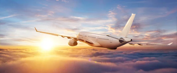 Passengers commercial airplane flying above clouds — Stock Photo, Image