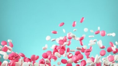 Mavi arka planda karışık hapların düşüşü çok yavaş. Yüksek hızlı sinema, yavaş çekim kamera, 1000fps.