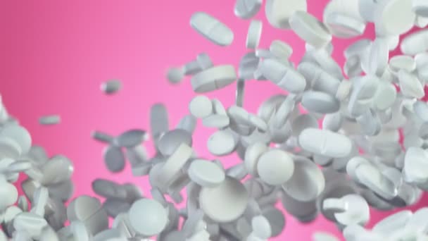 Super Slow Motion Falling White Pills Pink Background Filmed High — 비디오