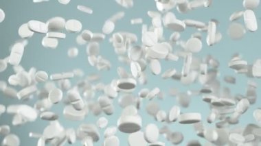 Beyaz arka plana düşen beyaz hapların süper yavaş çekimleri. Yüksek hızlı sinema, yavaş çekim kamera, 1000fps.