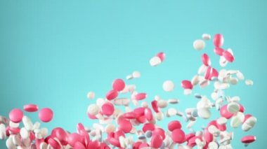 Mavi arka planda karışık hapların düşüşü çok yavaş. Yüksek hızlı sinema, yavaş çekim kamera, 1000fps.