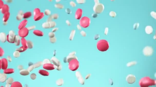 Super Slow Motion Falling Mixed Pills Blue Background Filmed High — Stock Video