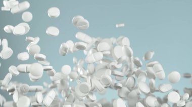 Mavi arka planda uçan hapların hareketlerini dondur