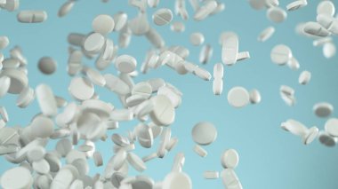 Mavi arka planda uçan hapların hareketlerini dondur