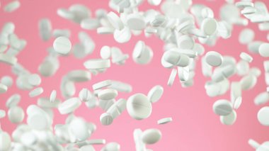 Pembe arka planda uçan hapların hareketlerini dondur