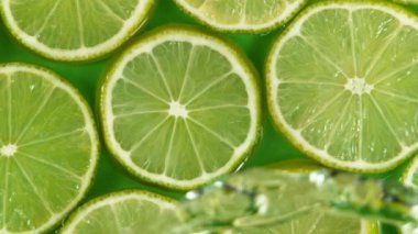 Super slow motion of lime slices with splashing water. Filmed on high speed cinema camera, 1000 fps.