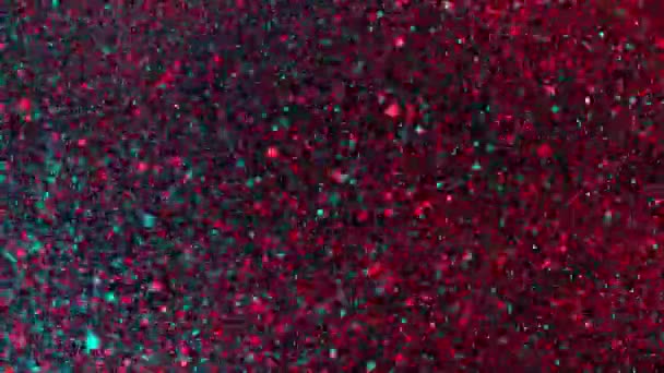 Mouvement super lent de particules colorées scintillantes sur fond noir. Faible profondeur de mise au point. Filmé sur caméra de cinéma à grande vitesse, 1000 images par seconde.