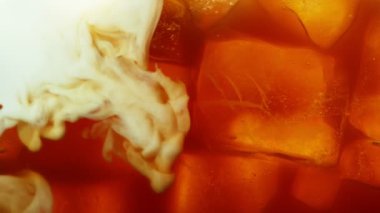 Buzlu kahve içeceğine süt koymanın süper yavaş bir yolu. Yüksek hızlı sinema kamerasıyla çekilmiş..