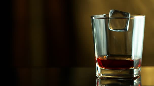 Super Slow Motion Falling Ice Cube Whiskey Filmed High Speed — Stock Video