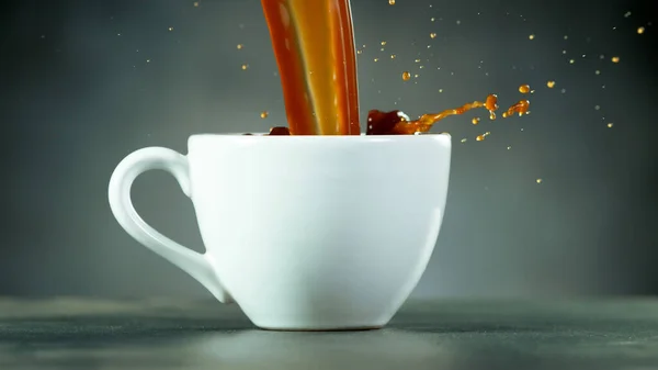 pouring coffee drink with splashing liquid. Closeup of vintage still life
