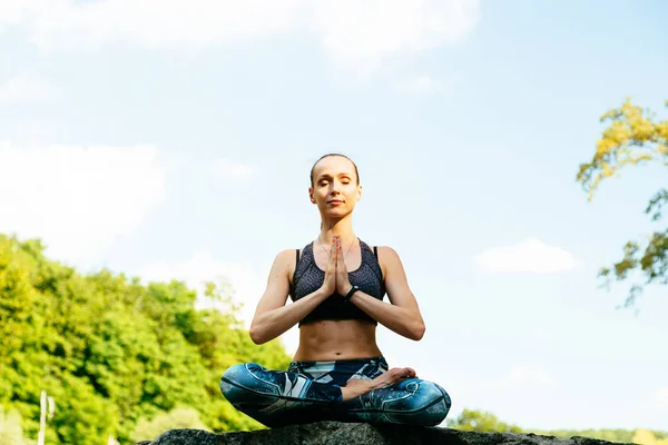 Yeşil Park 'ta yoga yapan genç bir kadın..