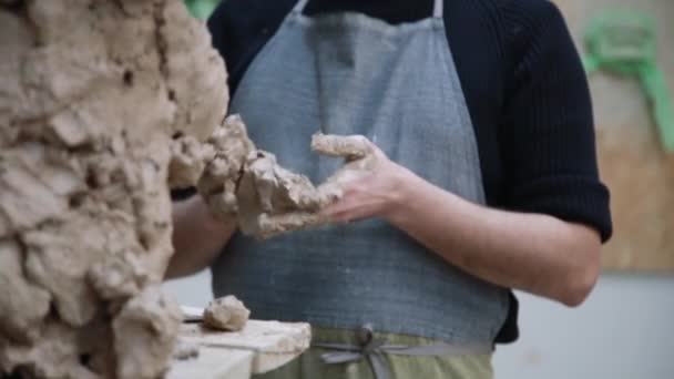 Sculptor modelling sculpture adjusting face details head made of clay. — Stock Video