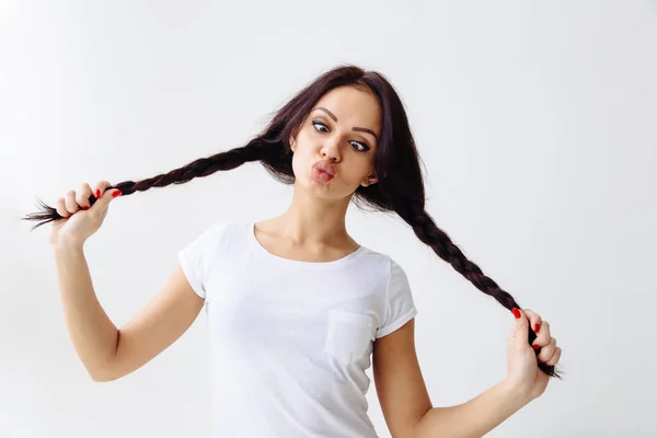 Squint eyed playful beautiful woman showing funny face weird expression isolated on white background. — Stock Photo, Image