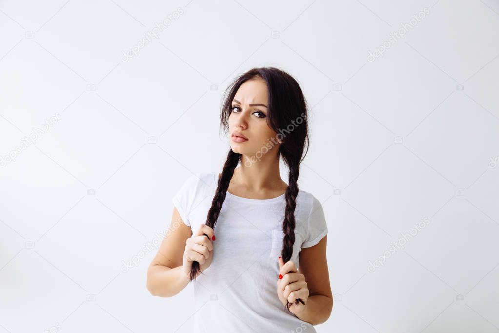 Portrait of young unsure hesitant nervous sad woman, isolated on white wall background. Negative human emotions facial expression feeling.