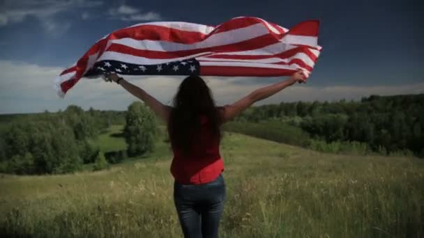 Proud american girl holding stars and stripes in slow motion — Stock Video