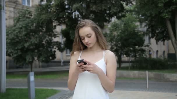 Mulher bonita elegante mensagens de texto no smartphone na cidade — Vídeo de Stock