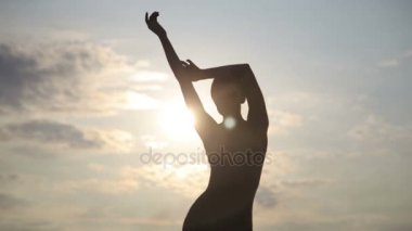 Genç güzel kadın giyiyor beden takım elbise çölde sunrise dans ediyor.