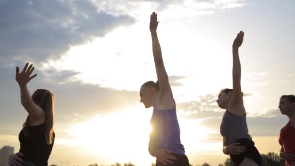 Mixed race group of people exercising yoga healthy lifestyle fitness warrior poses — Stock Video