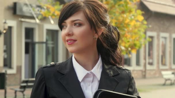 Beautiful smiling business woman on the background of the modern office. Holding tablet. — Stock Video