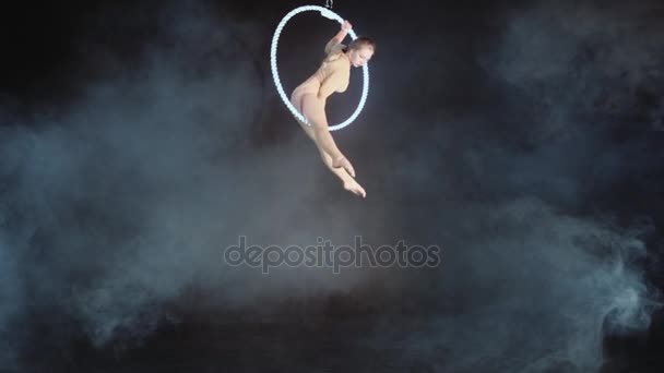 Rubia gimnasta en anillo aéreo bajo una cúpula. Hermoso caminante de cuerda floja en un traje de moda en un aro en el circo. El concepto de confianza y equilibrio — Vídeos de Stock