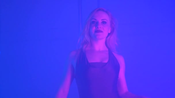 Молода сексуальна струнка жінка полюс танцює з пілоном в темному інтер'єрі — стокове відео