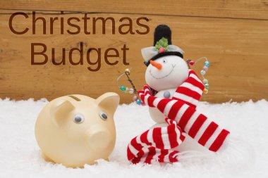 Bir Noel bütçe, kumbara ve kardan adam ile eşarp üzerinde sahip