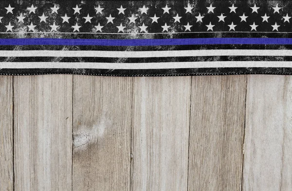 Thin blue line USA old flag on a weathered wood background