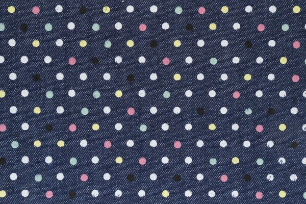 Dark blue denim with multicolored polka dot fabric background — Stock Photo, Image