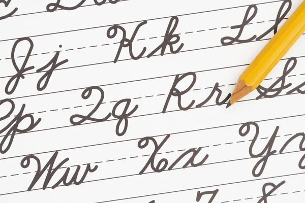 Learning to write cursive lettering — Stock Photo, Image