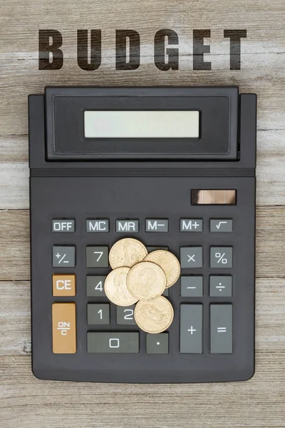 Taschenrechner mit Goldmünze auf verwittertem Holz — Stockfoto