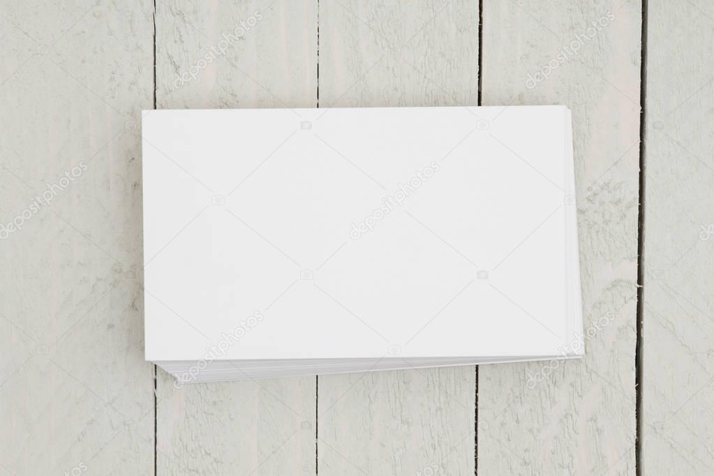 Stack of blank white index cards on weathered wood