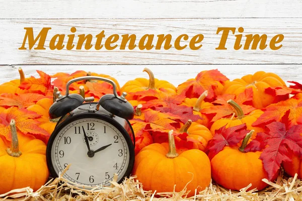 Maintenance Time message with a retro alarm clock with pumpkins — Stock Photo, Image